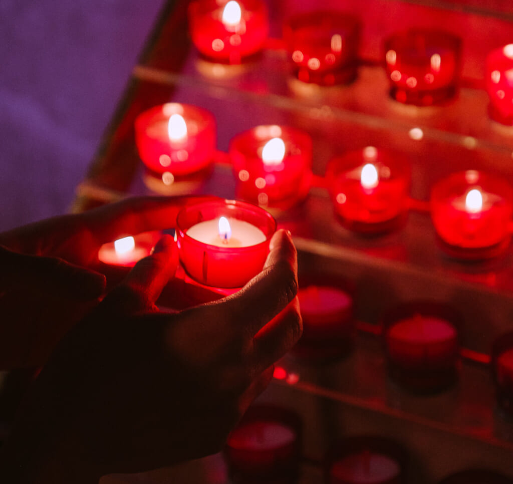 Hand holding a votive candle