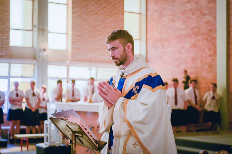 Father Tom conducts a school Mass at All Saints Catholic Church in Roma ...