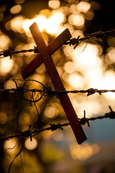 A crucifix tangled in barbed wire