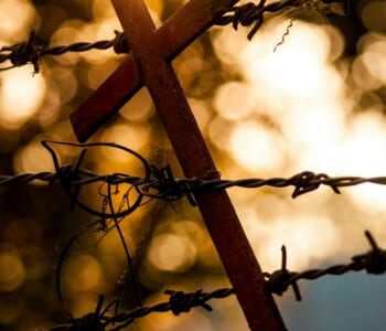 A crucifix tangled in barbed wire